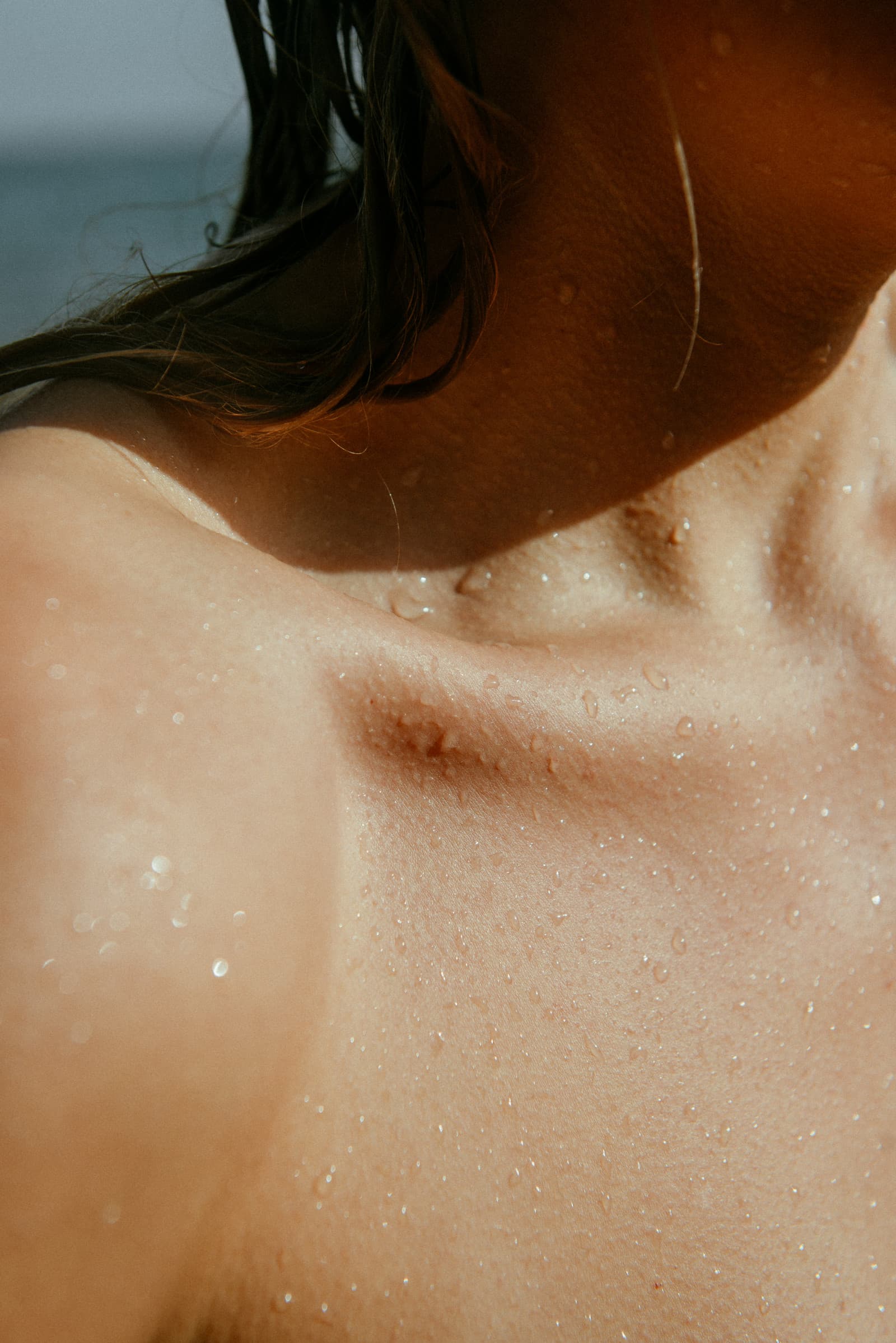 Close-up of water droplets on sunlit skin